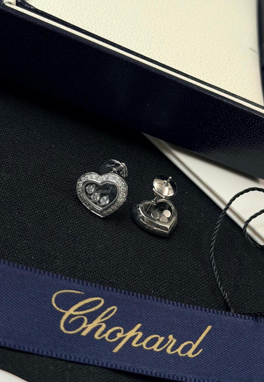 Chopard Happy Diamonds Heart Stud Earrings — White-Tone Metal with Three Floating Stones and Pavé-Set Heart Borders.