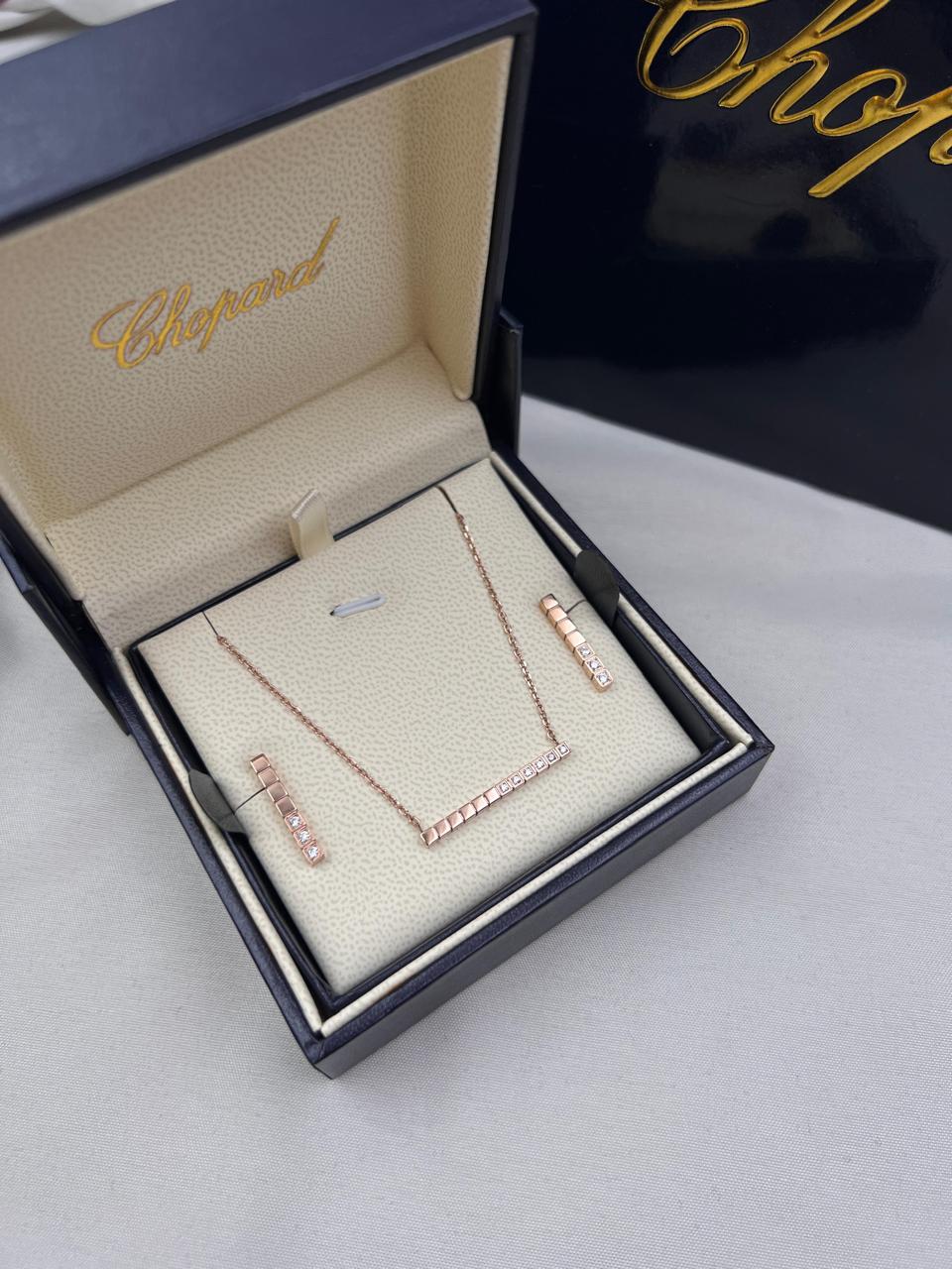 Chopard Ice Cube-Inspired Four-Piece Jewelry Set — -Tone Bar Pendant Necklace, Matching Stud Earrings, Chain Bracelet & Band Ring with Geometric Cube Detailing and Sparkling Stone Accents.
