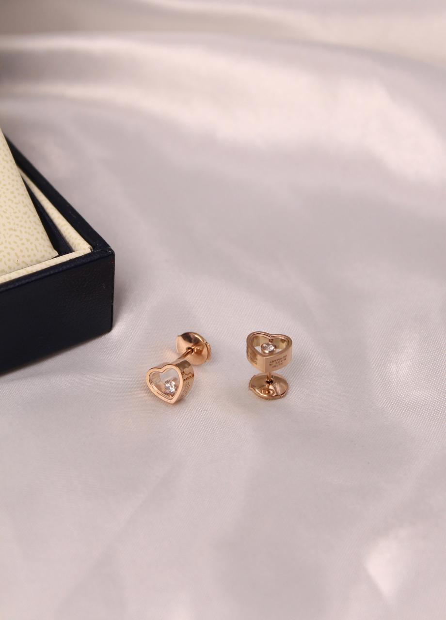 Chopard Happy Diamonds Happy Hearts Stud Earrings —  Heart-Shaped Design with Floating Diamonds.