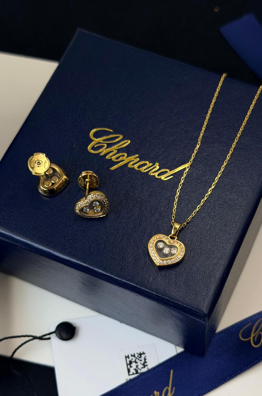 Chopard Happy Diamonds Heart Necklace & Earrings Set — Silver-Tone Design with Floating Diamond Details and Pavé-Set Heart Borders.